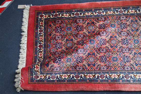 A Persian runner, 20ft 10in. x 2ft 6in.